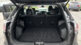SUV with rear hatch open, showing a large cargo area and folded third-row seats