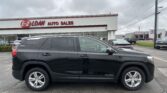 Dark gray GMC Terrain SUV parked in front of EZ Loan Auto Sales building on a cloudy day, dealership sign visible in background.