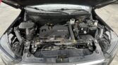 Open car hood showing engine bay with ECOTEC cover, battery, and various hoses and components.