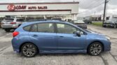 Blue sedan parked in front of the E-Z Loan Auto Sales storefront on a cloudy day, with other cars visible in the lot.