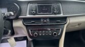 Center console with car radio display showing 103.3 FM and climate controls beneath; dashboard and hazard button visible.