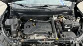Front of a Chevrolet with the hood open, showing the Ecotec engine cover and surrounding engine bay components.