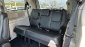 Back passenger row in a gray SUV with black leather seats, headrests, and visible seat belts.