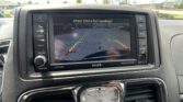 Infotainment screen showing rearview camera with parking guide lines and the message 'Check Entire Surroundings!'