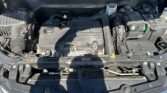 Front view of a Chevrolet engine bay with the hood open; ECOTEC engine cover visible and surrounding components like battery and reservoirs protruding above.