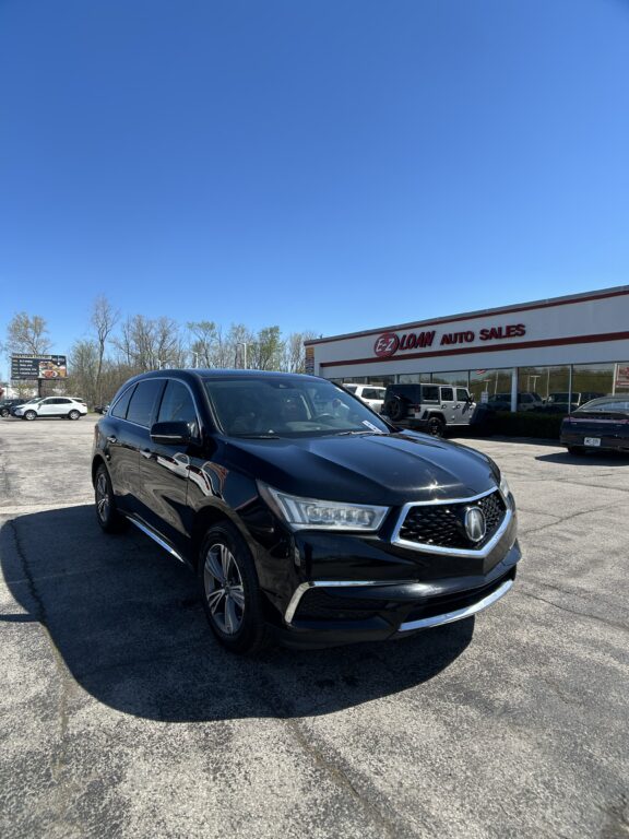 Black SUV in a parking lot in front of an E-Z Loan Auto Sales building under a clear blue sky, showroom vehicles visible in background.