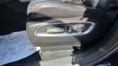 Leather car seat and center console with power recline/adjustment controls and chrome trim.