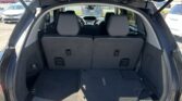 Rear open hatch of a black SUV showing the cargo area with third-row seats upright and gray interior.