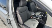 Open car door reveals the gray fabric front seats with headrests and center console visible inside the car.