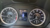 Instrument cluster of a car: speedometer on the right, tachometer on the left, center display shows 'P' and range of 123 mi with car icon and mileage 112,921 mi.