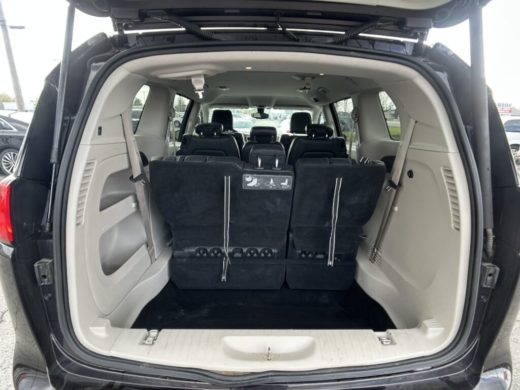 Open SUV rear with the third-row seats folded to create a large cargo area