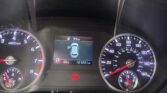 Car dashboard with speedometer on the right, tachometer on the left, and a central display showing 99 miles of range and Park gear (P).