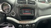 Interior of a car dashboard showing central infotainment screen, air vents, and control knobs