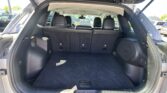 Open tailgate view of an SUV showing an empty cargo area with rear seats upright in black upholstery