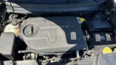 Open car hood exposing engine bay; visible V6 VVT engine cover, battery, and yellow coolant cap on right side.”