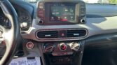 Center-console view of a car interior with the touchscreen showing 'AV Off', surrounding physical buttons, and steering wheel to the left.