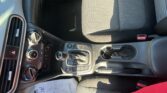 Front car interior focused on center console, gear shifter, and patterned front seats with a Kona floor mat visible.