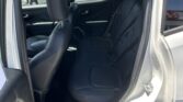 Rear passenger seating in a gray SUV with black leather seats, door open