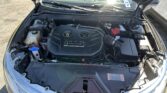 Open car hood showing the engine bay with an EcoBoost engine cover and battery on the right.