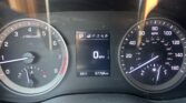 Close-up of car dashboard: tachometer on left, speedometer on right, center shows Park (P) and mileage 97,704 miles with 64°F outside temperature.