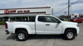 White Chevrolet Colorado pickup in front of a dealership sign reading 'E-Z LOAN AUTO SALES'.