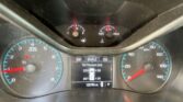 Vehicle dashboard with tachometer and speedometer; current speed 0 mph, engine idling, gear in Park, odometer reads 128,763 miles.