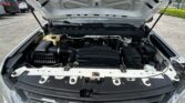 Open car hood revealing engine bay and components in the engine compartment