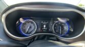 Front view of a car dashboard and steering wheel with the digital instrument cluster visible in the center display.