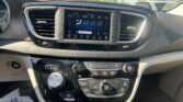 Interior car dashboard: center touchscreen with climate controls, two air vents, and gear selector (PRNDL) below.
