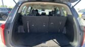 Open SUV rear cargo area with folded third-row seats and spacious trunk space