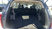 Open tailgate of an SUV showing the clean, empty cargo area with the third-row seats upright
