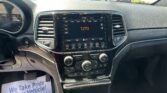 Center console touchscreen showing 1270 AM and climate controls, with a dealership lot visible through the windshield