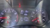 Red seatbelt warning light illuminated on car dashboard with gear in Park and 0 mph on the digital display center.