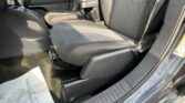 Interior of a car showing the front driver and passenger seats with center console and seat belts visible.