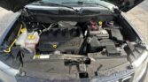 Open car hood showing engine bay with battery on the right and coolant reservoir on the left; engine cover reads 'DUAL VVT 2.4L'.