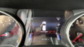 Close-up of a car dashboard showing the digital instrument cluster: Door Open message, 92-mile range, date 06/09/26, odometer reading 121101 miles, gear in Park.
