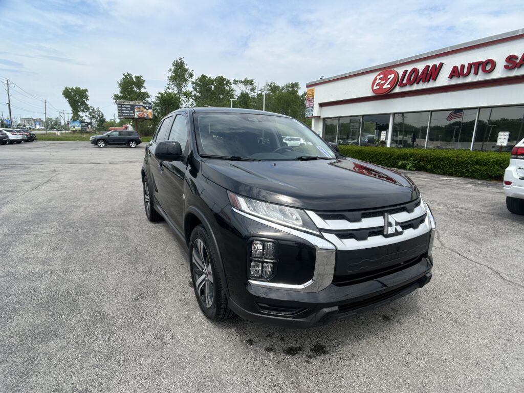 Front-right angle of a black SUV in a dealership lot with the EZ Auto building in the background.