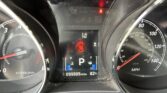 Dashboard cluster with warning lights (seat belt, brake) and service engine sooner indicators, odometer 099505 miles, 82°F shown on display.