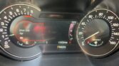 Instrument cluster showing a Driver Door Ajar warning, with left tachometer and right speedometer visible and 134,084 mi shown in the dash readout.