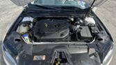Open hood reveals engine bay with EcoBoost engine cover visible in center