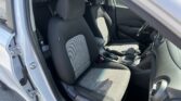 Interior of a car with front seats visible, center console and gear shifter in view, driver door open in daylight
