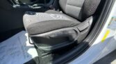 Interior of a car showing the front seats, center console with gear selector, and handbrake.