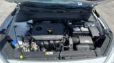 Car engine bay with hood open, showing the battery on the right and engine cover labeled DOHC 16V in the center.