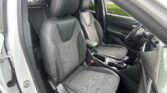 Interior of a car showing the front seats with black upholstery, center console, and steering wheel on the right (right-hand drive).