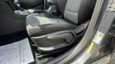 Interior shot of a car front cabin showing the driver's seat, center console, and gear shifter with patterned seat upholstery.