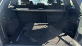 Open SUV cargo area with folded floor mats and rear seats visible through the spacious trunk