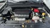 Open hood revealing a car engine bay; prominent 2.4L MultiAir engine cover, red battery, and yellow-capped fluids nearby