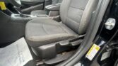 Front passenger seat and center console of a car interior, with gear shifter and a yellow warning label on the door jamb