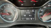 Close-up of a car's instrument cluster: tachometer on left, speedometer on right, center digital display showing fuel range and mileage (83,428 mi).