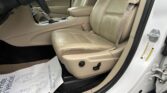 Beige leather car interior with front passenger seat, center console, and gear shifter visible through open car door.